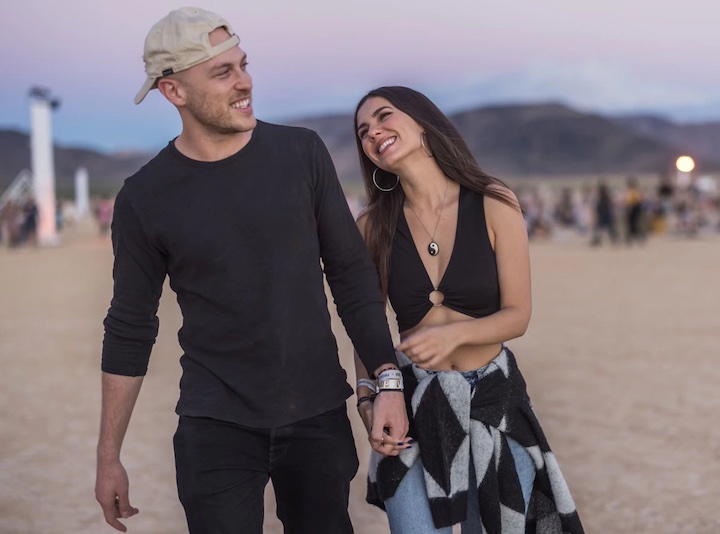 Victoria Justice and Evan Berger walking hand-in-hand on the beach Las Vegas’ RiSE festival in October 2022.