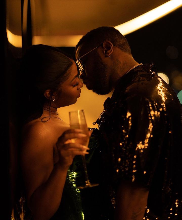 Yung Miami celebrating New Year's eve 2023 with rumored boyfriend Diddy in a near-kiss moment.